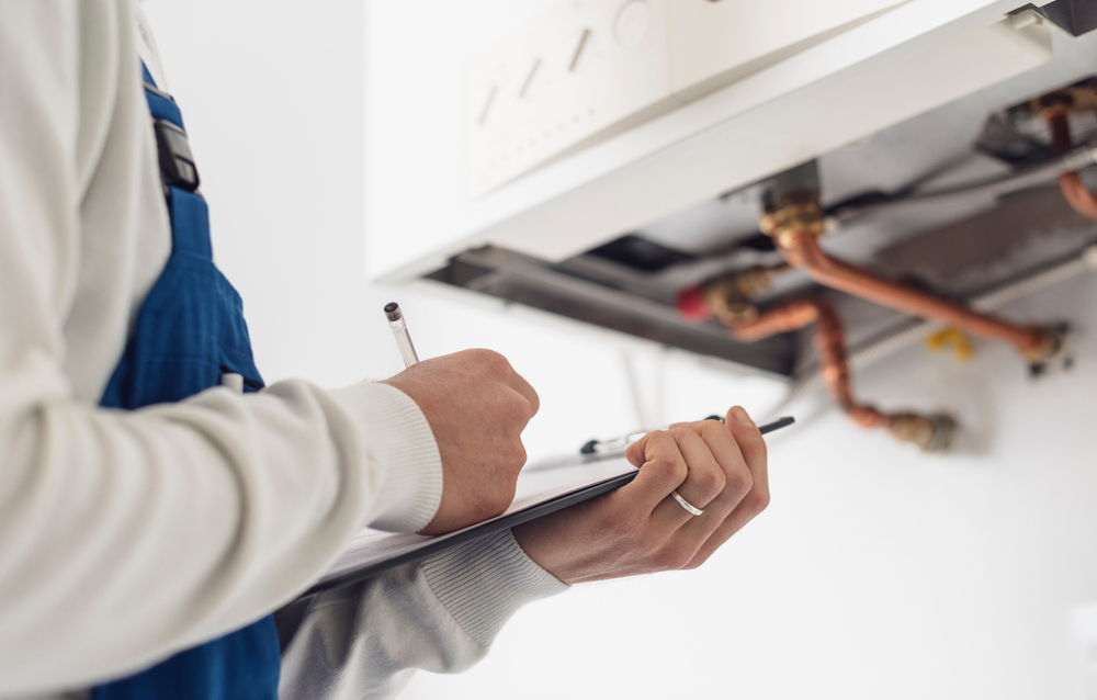 Gas engineer carrying out boiler servicing
